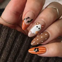 Uñas halloween sencillas con fantasmas, murciélagos y flores. Un diseño adorable y fácil para la noche de brujas.