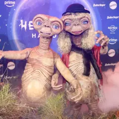 Dos E.T. disfrazados, uno con sombrero y peluca rubia, celebran Halloween. ¡Un guiño a Heidi Klum!