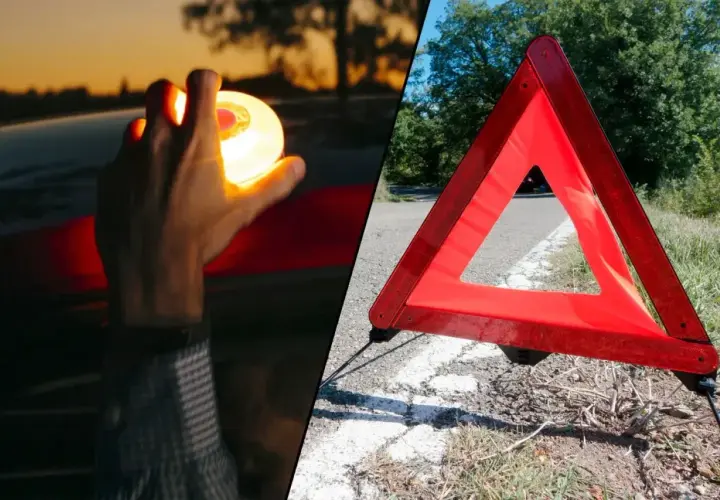 Mano sostiene luz de emergencia, junto a un triangulo virtual v27 en la carretera.