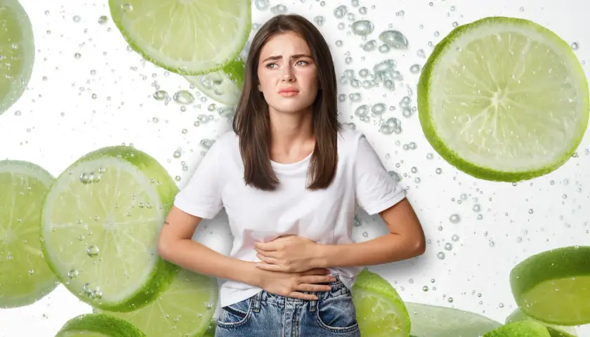 Mujer con cara de dolor, sujetándose el abdomen, rodeada de rodajas de limón y burbujas. ¿Será que el limón estriñe?